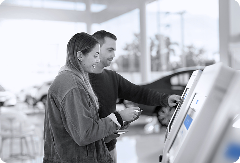 Customers using TDC digital deal jacket on the kiosk at the showroom